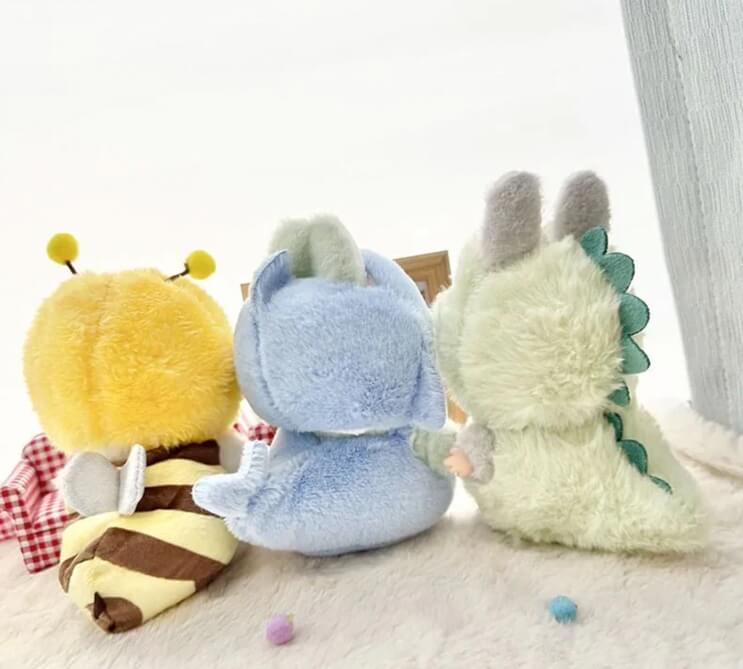 Adorable Labubu figure dressed in soft green dinosaur clothing by Zibuya.