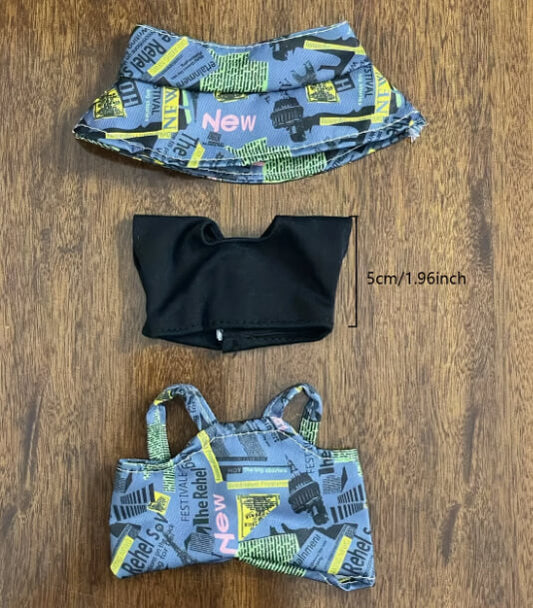 Flat lay of Zibuya’s Labubu doll clothing set, including a newspaper-print bucket hat, black cropped T-shirt, and matching overalls, designed for stylish collectible displays.