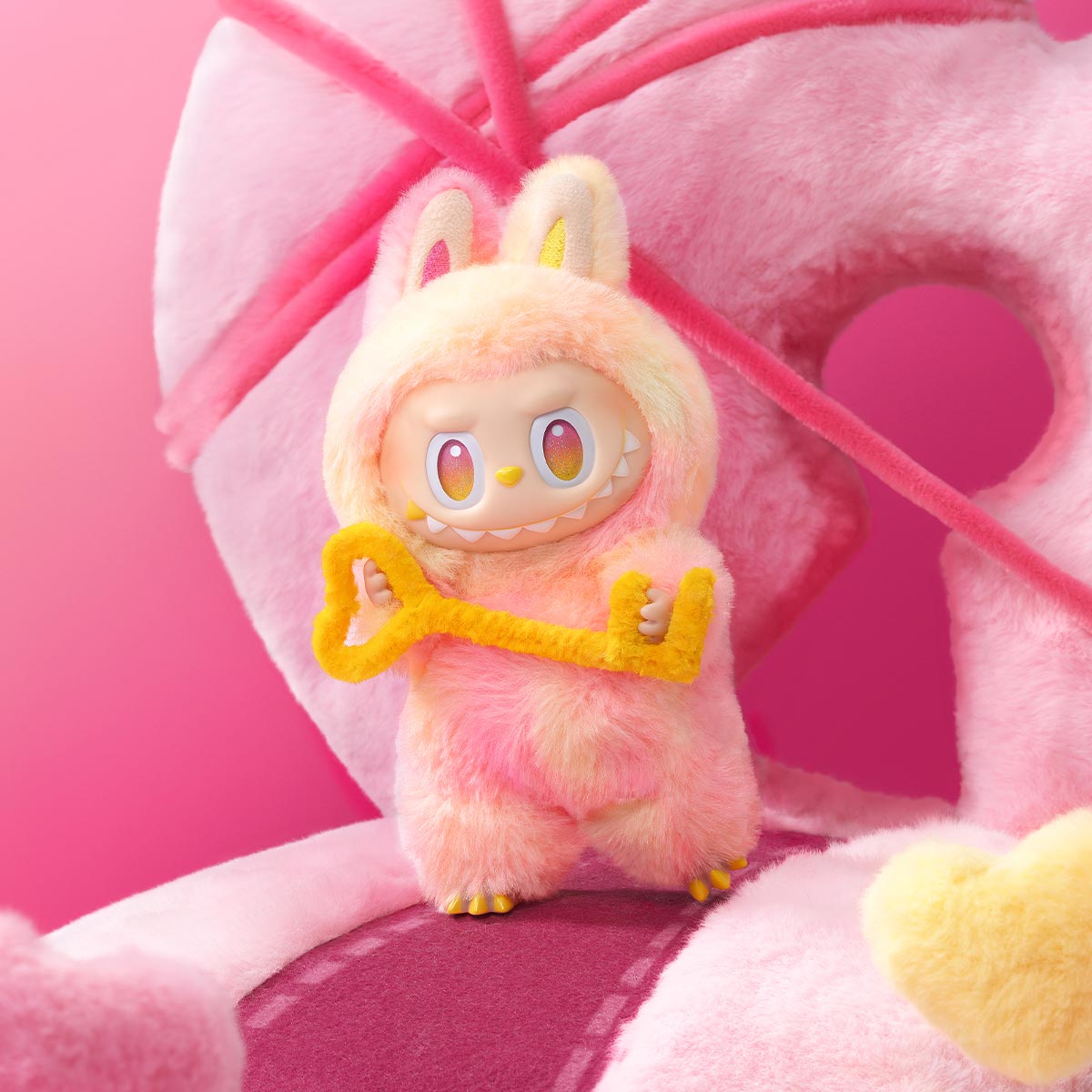 Zibuya Loyalty Labubu, Peach and yellow plushie holding a fuzzy key, part of The Monsters Big Into Energy lineup by Pop Mart.